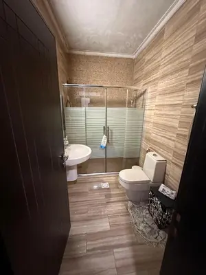 a bathroom with a toilet and a tub and a sink at كريستال in Amman