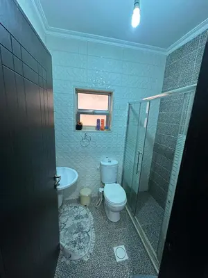 a bathroom with a toilet and a shower and a sink at كريستال in Amman