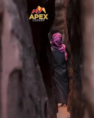 a woman walking down a tunnel with a pink hijab at VELVET WADi RUM LUXURY in Wadi Rum