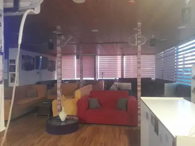 a living room with a red couch in a room at bedouin hostel in Amman