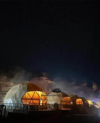 a group of domes with lights in the dark at RUM MARS lUXURY SANDS BUBBLE CAMP in Wadi Rum
