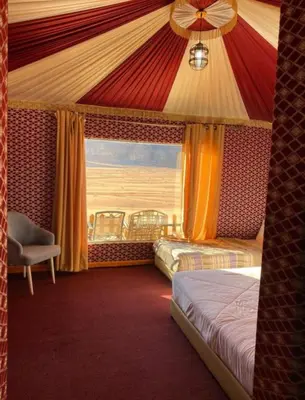 a hotel room with two beds and a window at Welcome to Wadi Rum in Wadi Rum