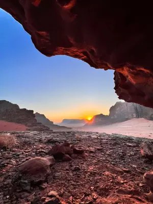 a view of the sunset from a cave in the desert at wadi Rum Spirit of Peace Camp in Wadi Rum