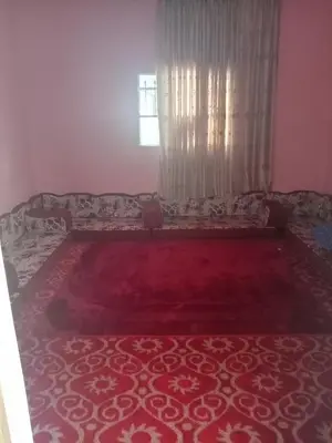 a living room with a couch and a window at Hello hostel in Amman