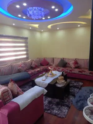 a living room with a couch and a blue ceiling at Hello hostel in Amman
