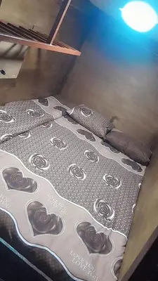 a bed with chocolate hearts on it in a room at Gorge home in Amman