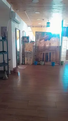 a room with a wooden floor and a painting on the wall at Gorge home in Amman