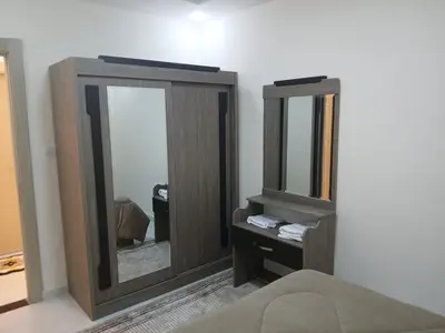 a bedroom with a mirror and a dresser with a bed at شقق السعادة 1 in Amman
