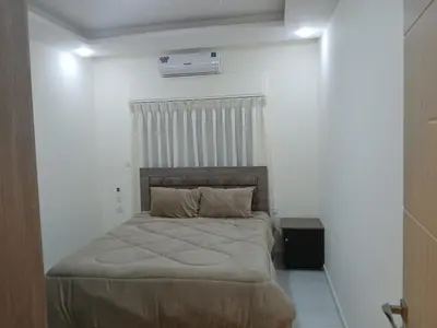a bedroom with a bed in a white room at شقق السعادة 1 in Amman