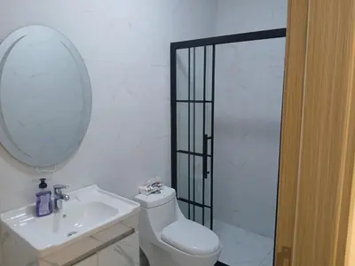 a bathroom with a toilet and a sink and a mirror at شقق السعادة 1 in Amman