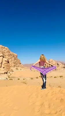 a woman holding a kite in the desert at Wadi Rum Red Desert in Wadi Rum