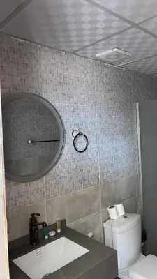 a bathroom with a sink and a toilet and a mirror at Monica Wadi Rum in Wadi Rum