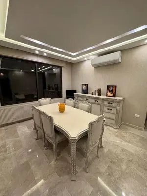 a dining room with a table and chairs at Bargos Cave in Amman