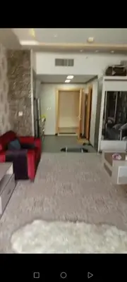 a living room with a red couch in a room at برج داماك الطابق in Amman