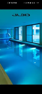 a large building with blue lights on the floors at شقه دوبلكس داماك العبدلي in Amman