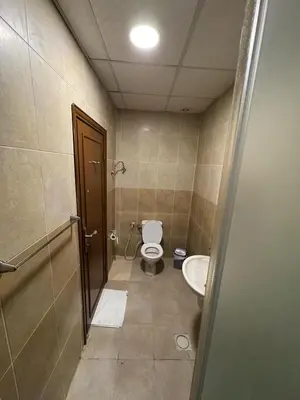 a bathroom with a toilet and a sink at Al-RAYAN HOTEL SUITES in Amman
