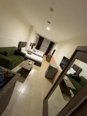 an overhead view of a living room with a green couch at Al-RAYAN HOTEL SUITES in Amman