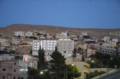 a view of a city at night with buildings at Uncle Ali hotel in Wadi Musa