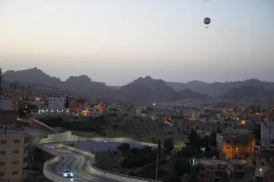 a view of a city with buildings and mountains at Uncle Ali hotel in Wadi Musa