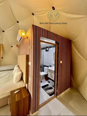 a room with a bed and a mirror in a tent at RUM STAR VIEW BUBBLES lUXURY CAMP in Wadi Rum