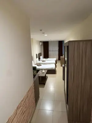 a hospital room with two beds and a waiting room at Ryan Hotel Suites in Amman