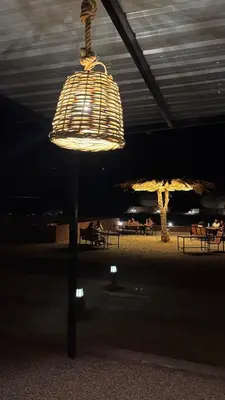a bird cage light on a pole in a building at RUM HiLTON lUXURY CAMP in Wadi Rum