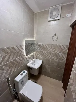 a bathroom with a toilet and a sink at Nora Bedouin Home in Petra
