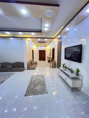 a large living room with a flat screen tv on a wall at Nora Bedouin Home in Petra