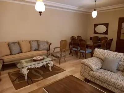 a living room with a couch and a table at Happy Family Home with Spacious Garden in Amman