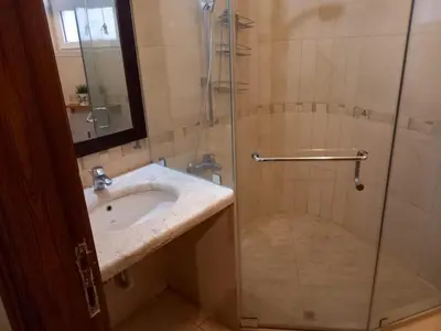 a bathroom with a sink and a shower at Happy Family Home with Spacious Garden in Amman