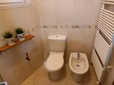 a small bathroom with a toilet and a bidet at Happy Family Home with Spacious Garden in Amman