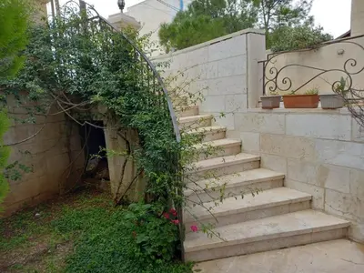 a set of stairs leading up to a house at Happy Family Home with Spacious Garden in Amman