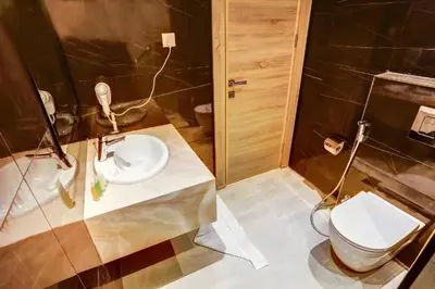 a bathroom with a sink and a toilet at Turquoisejo Hotel in Aqaba