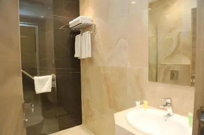 a bathroom with a sink and a shower at Turquoisejo Hotel in Aqaba