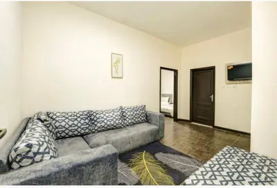 a living room with a couch and a television at Magic Waves Hotel Aqaba in Aqaba