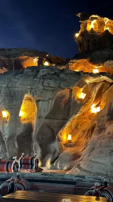 a rock formation with lights on it at night at Princess Camp in Wadi Rum