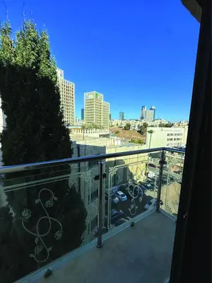 a balcony with a view of a city at Alsadi Housing- Jabal Amman in Amman