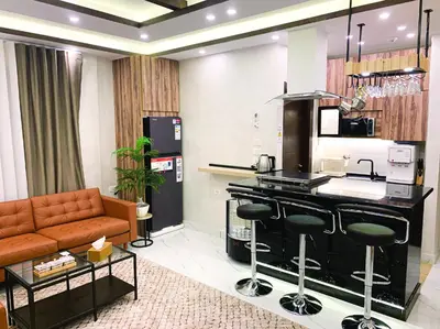 a living room with a couch and a kitchen at Alsadi Housing- Jabal Amman in Amman