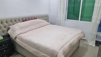 a bed in a bedroom with a window at Beit Alhana in Amman