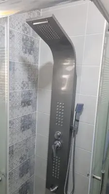 a shower with a black shower head in a bathroom at Beit Alhana in Amman