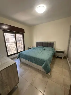 a bedroom with a bed and a large window at Royal in Amman