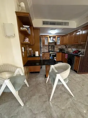 a kitchen with two chairs and a table at Royal in Amman