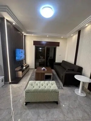 a living room with a couch and a table at Royal in Amman