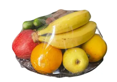 a bowl of fruit with bananas apples oranges and lemons at Desert Waves Camp in Wadi Rum