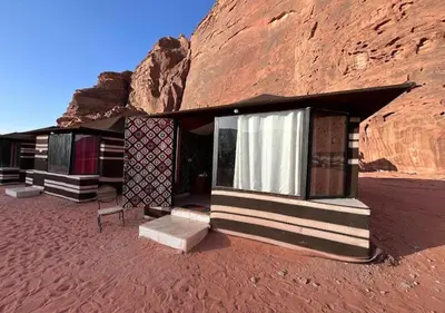 a building in the middle of a desert at Desert Waves Camp in Wadi Rum
