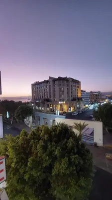 a large building in a city at night at فندق الشلالات العقبه Waterfalls Hotel Aqaba in Aqaba