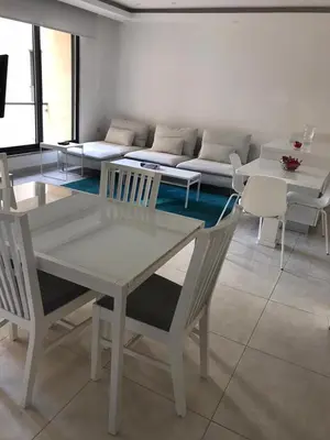 a living room with a table and chairs and a couch at Luxurious cozy apt 2 in Amman