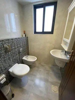 a bathroom with a toilet and a sink at Luxurious cozy apt 2 in Amman