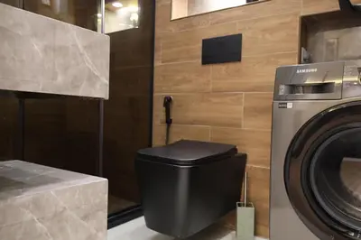 a bathroom with a washing machine and a toilet at A luxurious apartment for relaxation in Amman in Amman