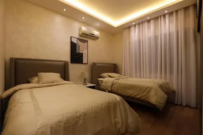 a bedroom with two beds and a window at A luxurious apartment for relaxation in Amman in Amman